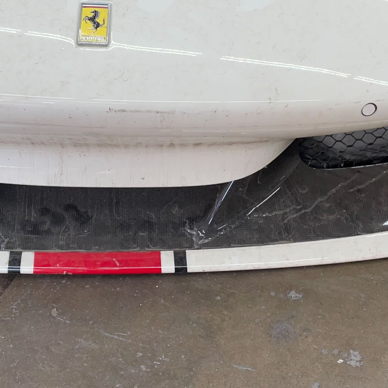 Before: Ferrari F8 front carbon fiber showing visible finish damage